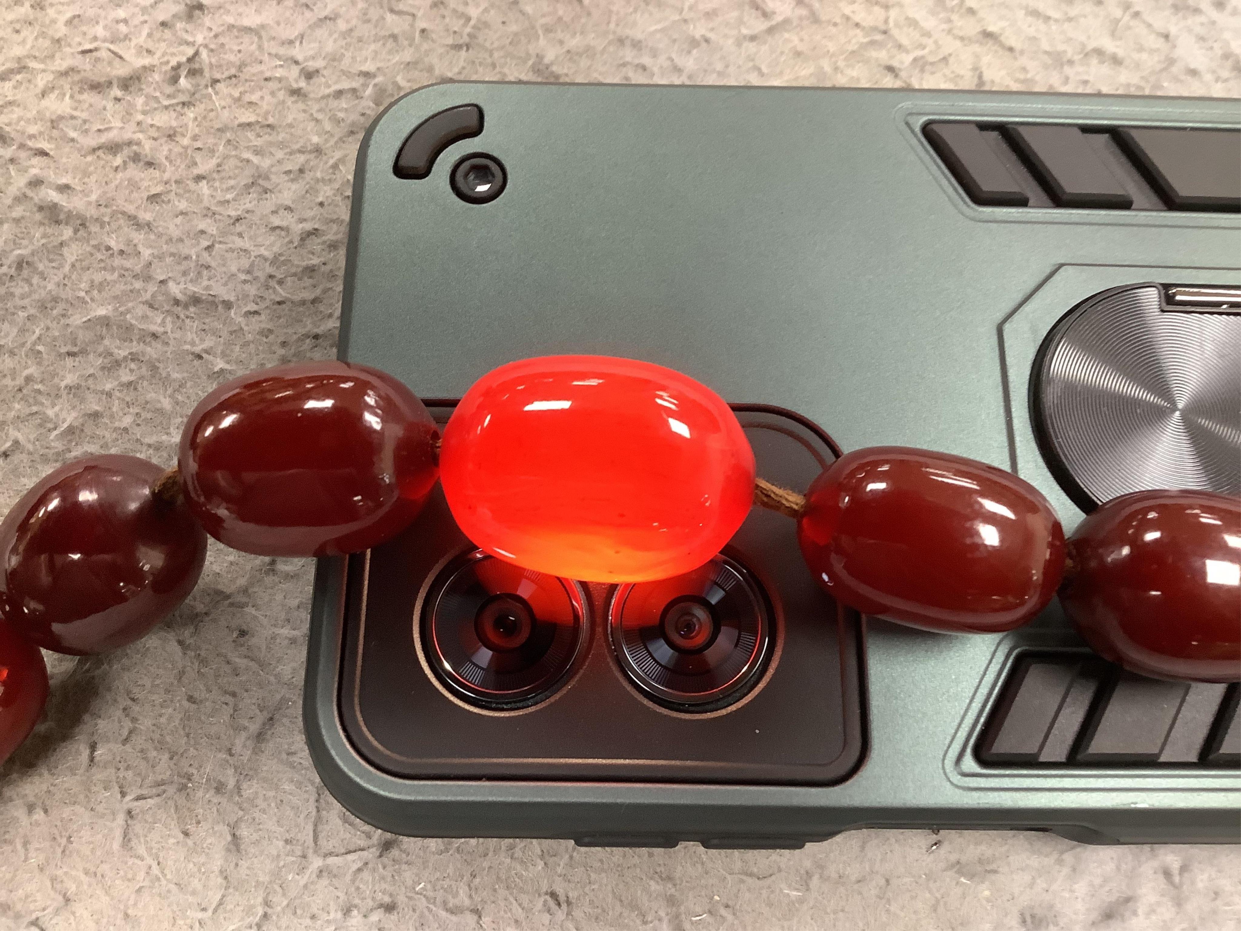 A single strand graduated simulated cherry amber bead necklace(beads missing), 30cm, together with seven similar loose beads, gross weight 149 grams. Condition - poor to fair